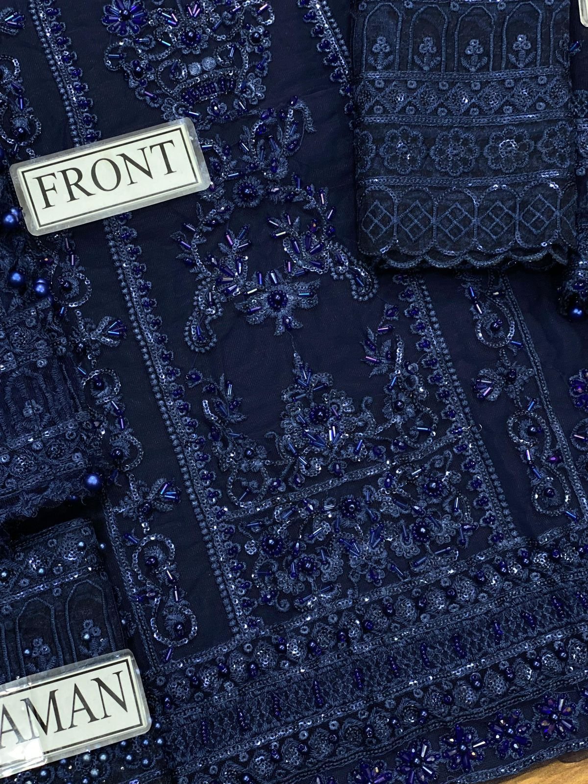 Close-up view of the heavy handwork Adda embroidery and sequence work on the front shirt and daman of the luxury net wedding suit