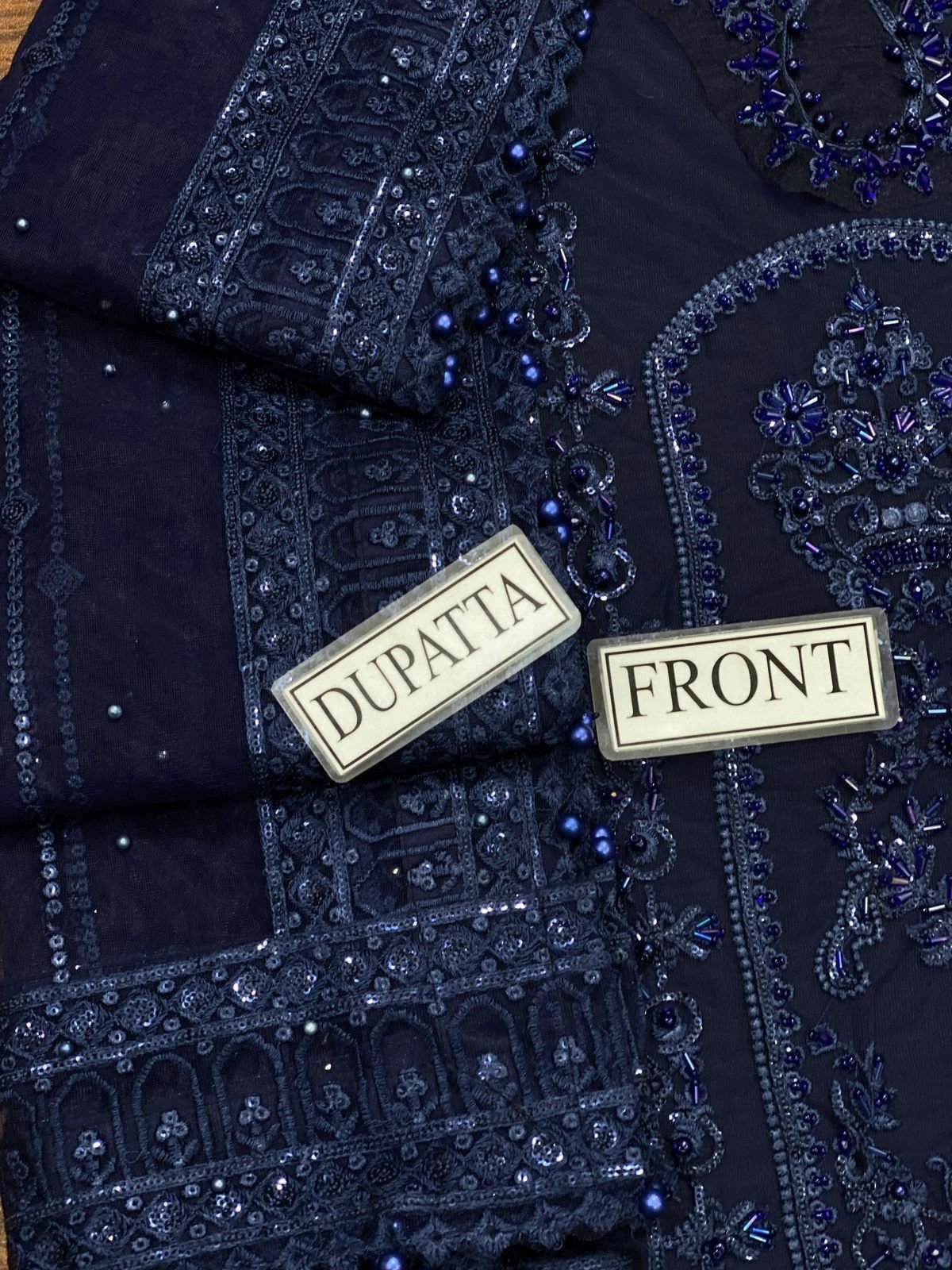 Intricate sequence embroidery and premium bead detailing on the front panel and net dupatta of a luxury handwork wedding suit